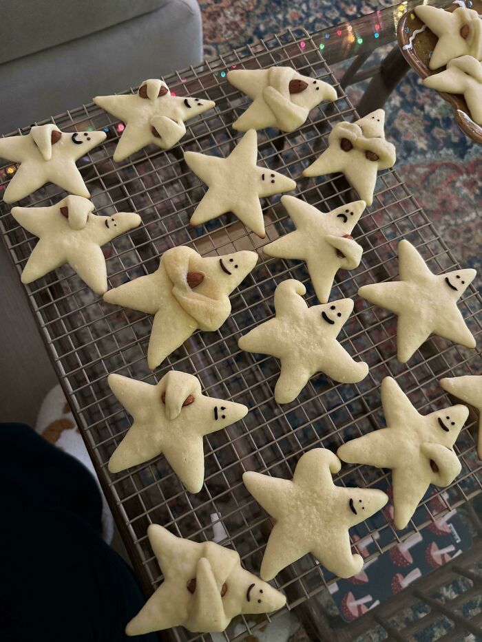 Charming star-shaped cookies with playful face designs, fresh from the oven.