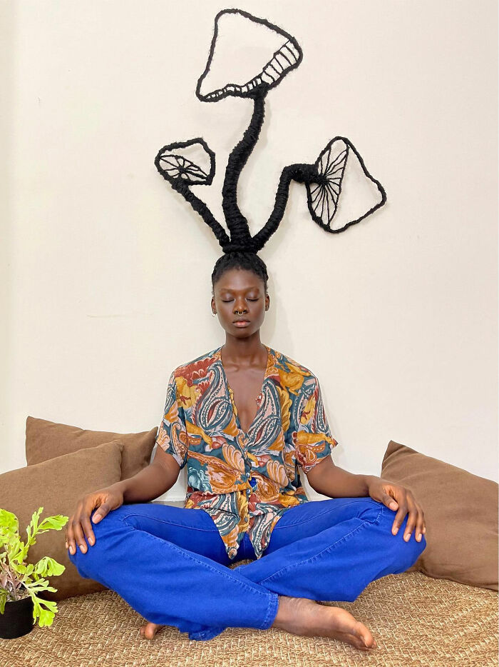 Woman with hair sculpted into artful mushroom_ shapes, sitting=
