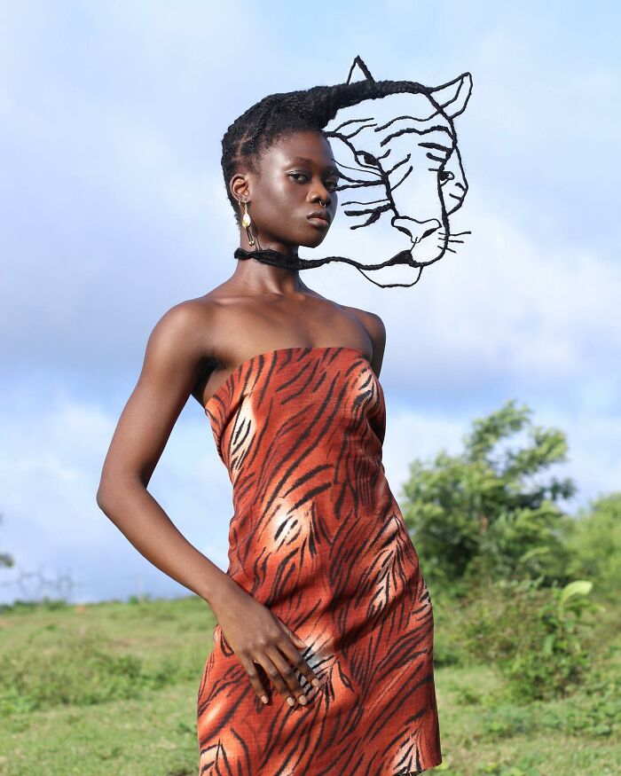 Hair sculpture of a lion face paired with a tiger-print dress, showcasing bold artistry.