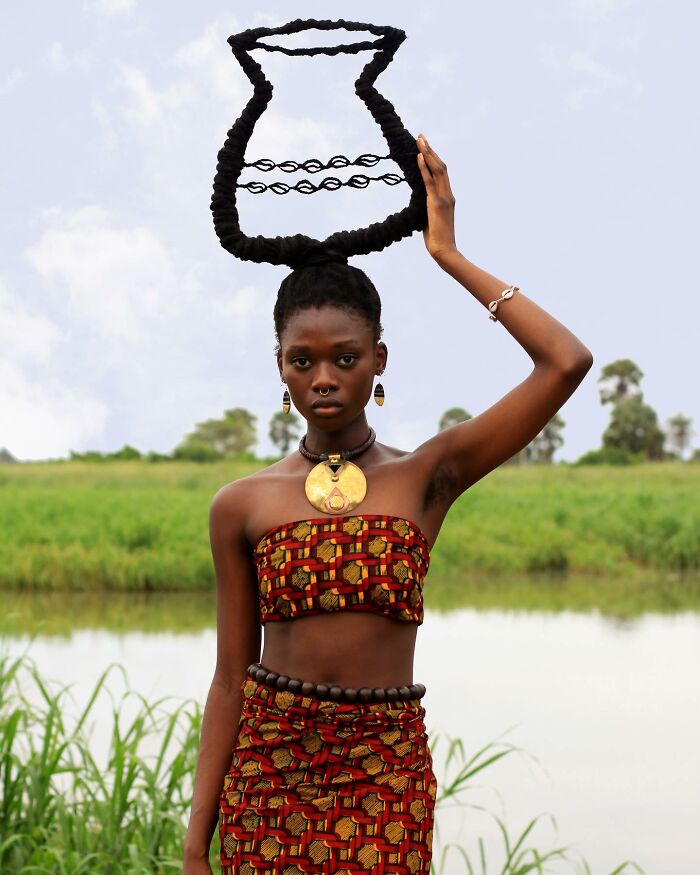 Hair sculpture shaped like a vase, paired with a colorful-outfit in a scenic setting.
