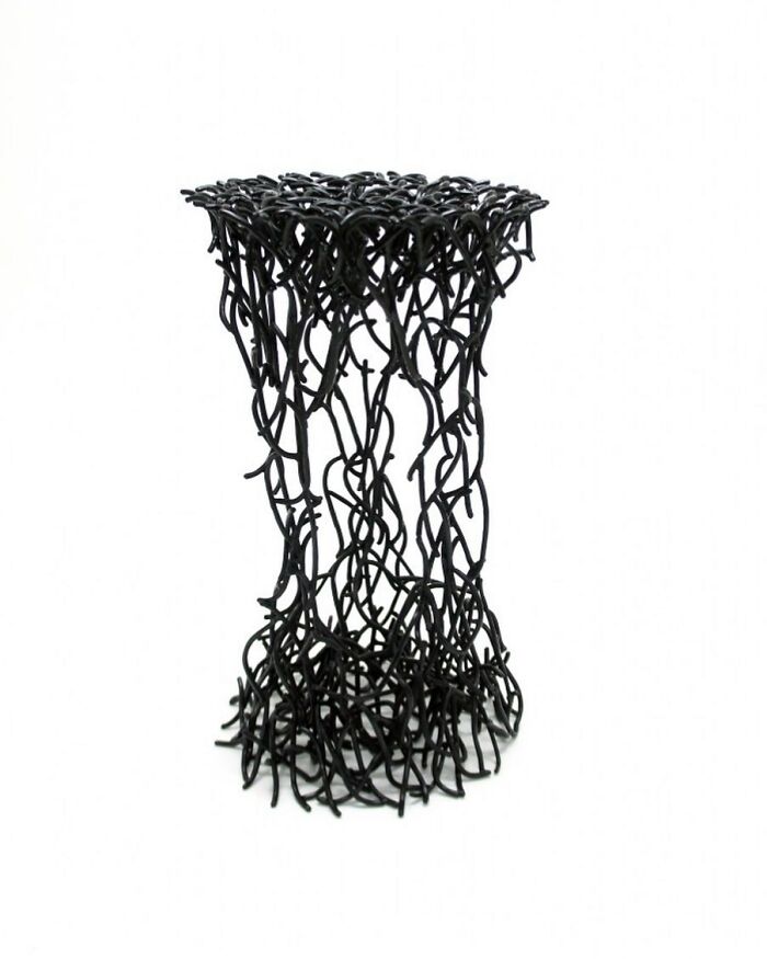 Black abstract furniture piece made of tangled metal rods, resembling doodles from a notebook by Jinil Park.