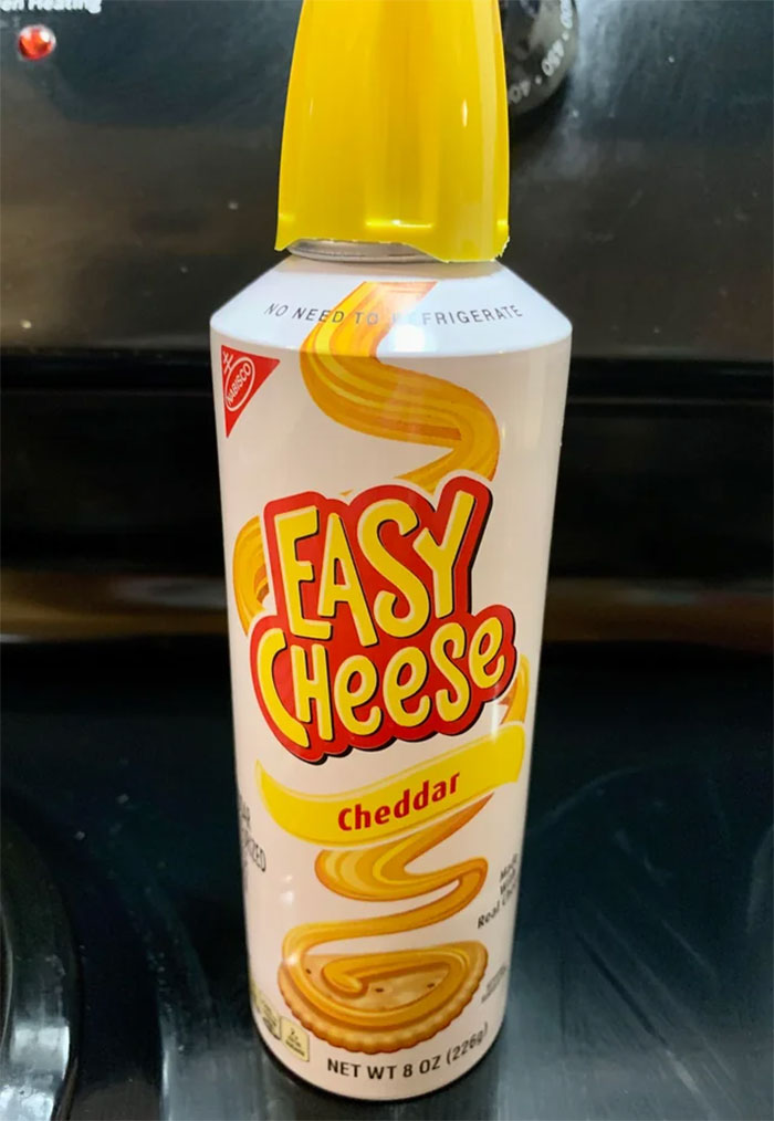 Easy Cheese can, cheddar flavor, showcasing American food available in international stores.