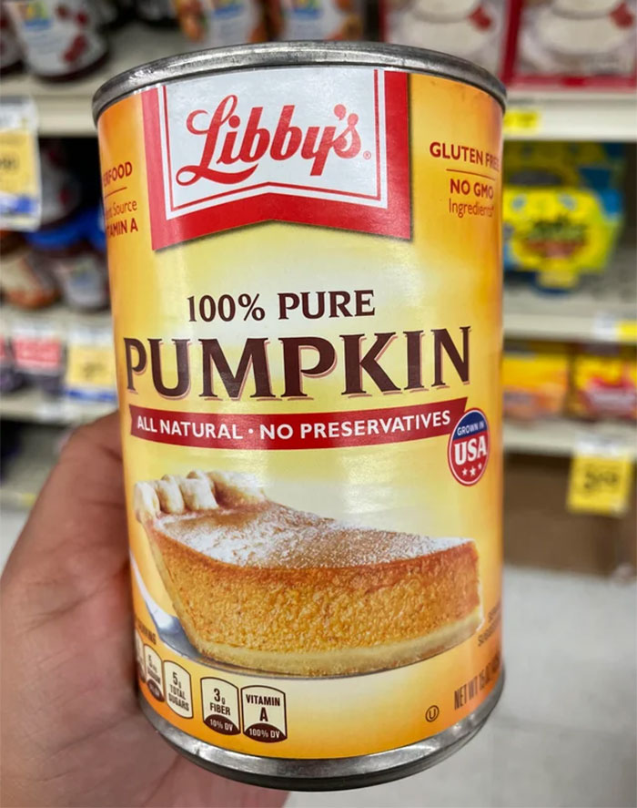 A can of Libby’s pure pumpkin, an American food product, held in a store aisle.