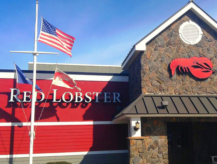 Red Lobster chain restaurant exterior with flags, highlighting employees warning about items never to order.