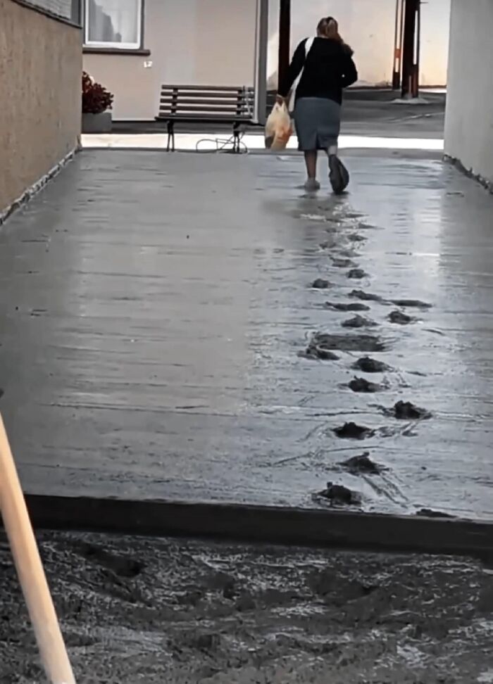 Person walking away leaving footprints in wet concrete, an unexpected fail showing anything gone wrong in construction.