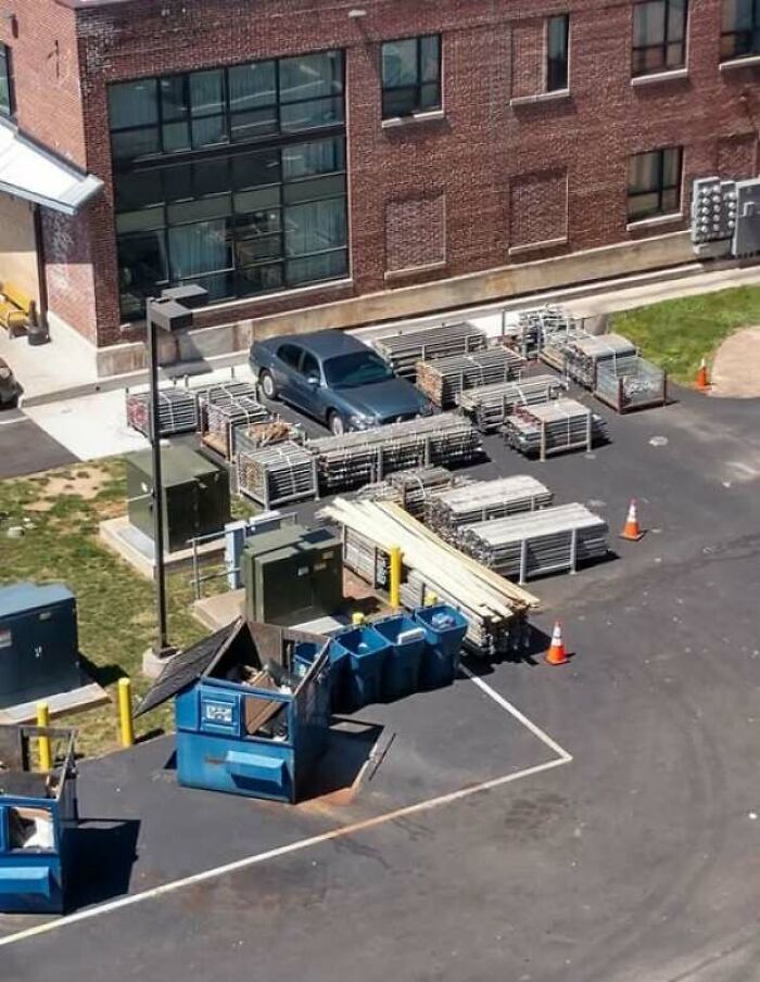 Car trapped in a fenced construction area demonstrating unexpected fails and anything gone wrong in a parking lot.