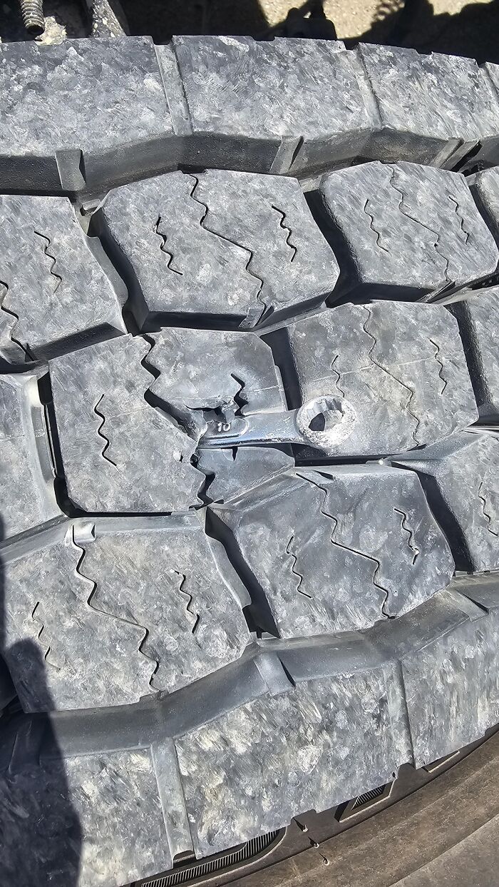 Close-up of a tire with a broken wrench stuck in the tread, an unexpected fail showing anything gone wrong.