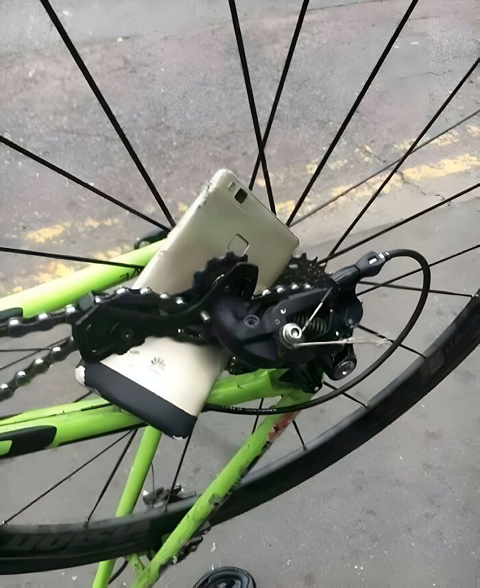 Smartphone stuck in bike chain and gears showing an unexpected fail in the anything gone wrong group.