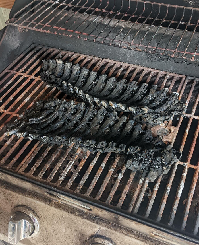 Charred ribs on a rusty grill, a funny and painful cooking fail.