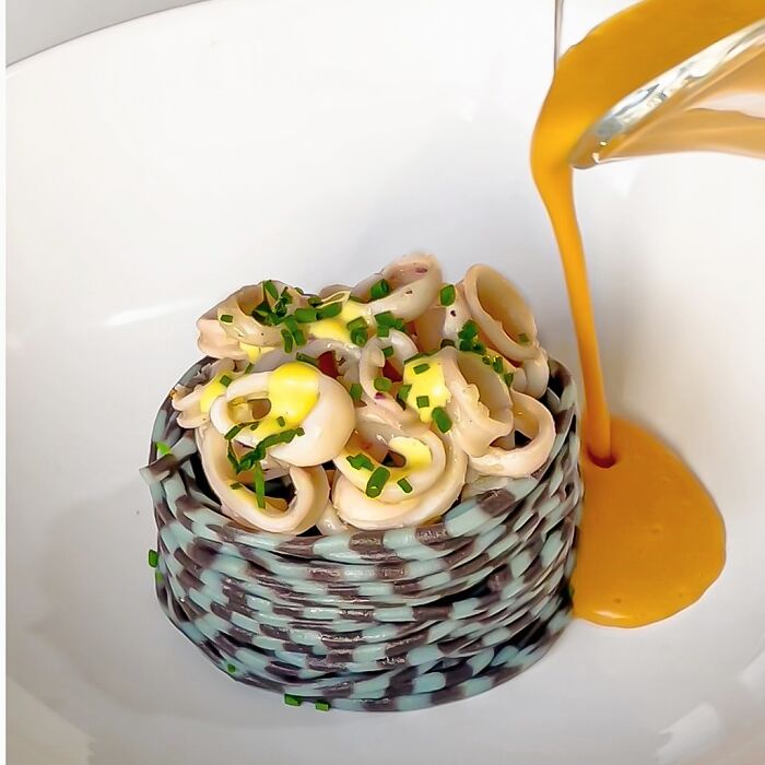 Artistic pasta dish with colorful sauce, highlighting a chef's creative culinary patterns and colors. Artistic pasta dish with colorful sauce, highlighting a chef's creative culinary patterns and colors.