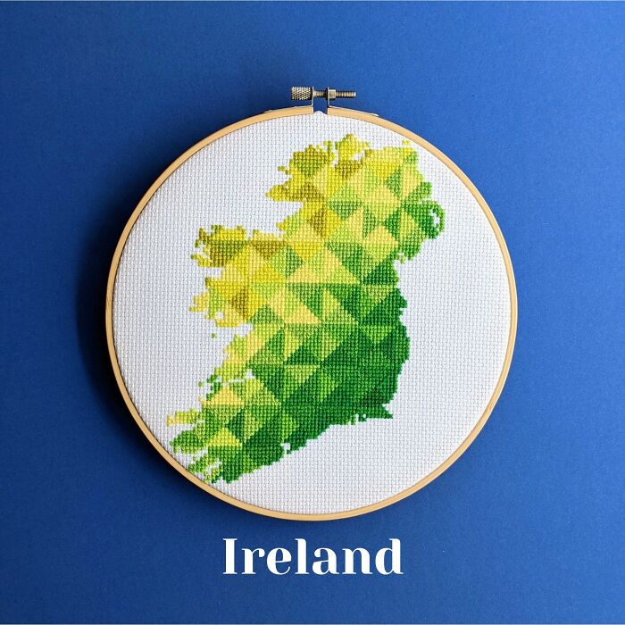 Ireland’s map in lush greens and yellows, stitched with love and framed in a hoop on a blue background.