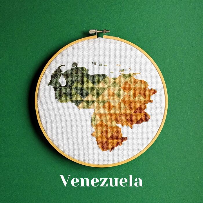Venezuela’s map in vibrant greens and oranges with geometric patterns, stitched on white fabric.