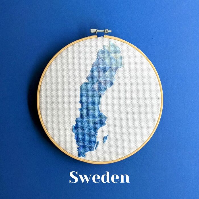 Sweden’s map in cool blue shades, delicately stitched and framed in a hoop on a matching blue background.